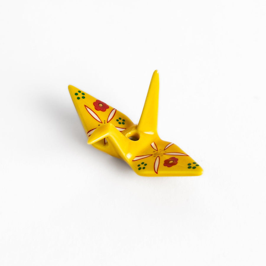 Colorful yellow origami crane incense holder with intricate floral patterns, perfect for adding charm and serenity to your space.