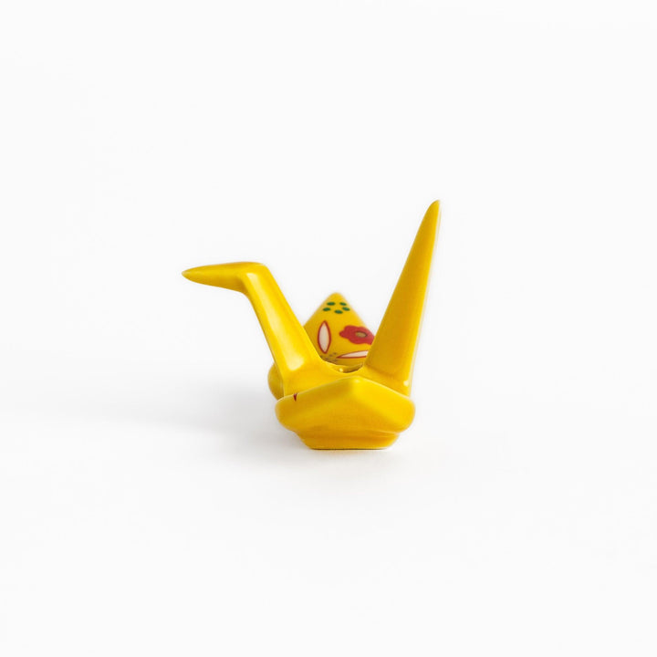 Colorful yellow origami crane incense holder with intricate floral patterns, perfect for adding charm and serenity to your space.
