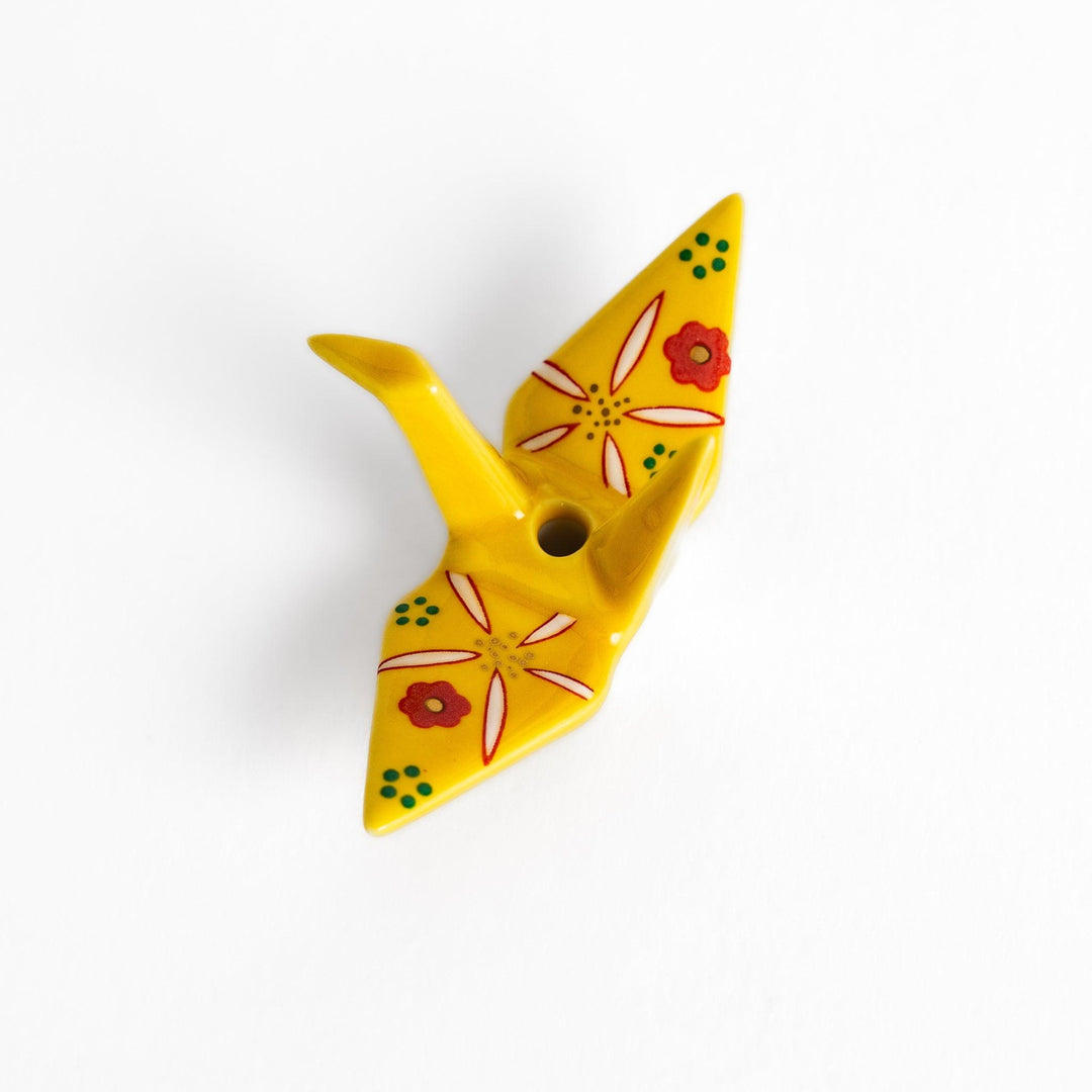 Colorful yellow origami crane incense holder with intricate floral patterns, perfect for adding charm and serenity to your space.