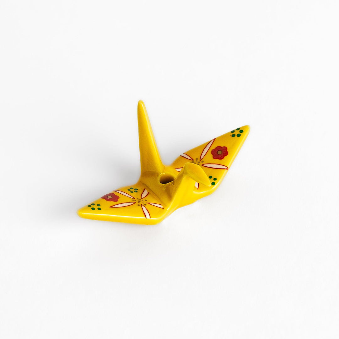 Colorful yellow origami crane incense holder with intricate floral patterns, perfect for adding charm and serenity to your space.