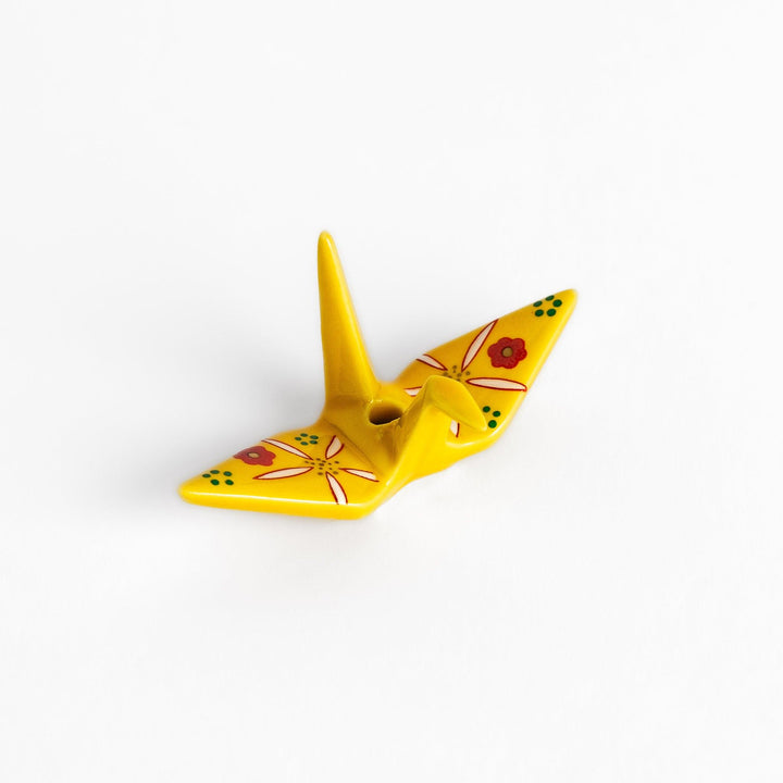 Colorful yellow origami crane incense holder with intricate floral patterns, perfect for adding charm and serenity to your space.