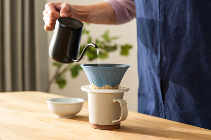 Nami from Just One Cookbook holding a Mount Fuji ceramic coffee filter at the Sancera workshop in Kyushu