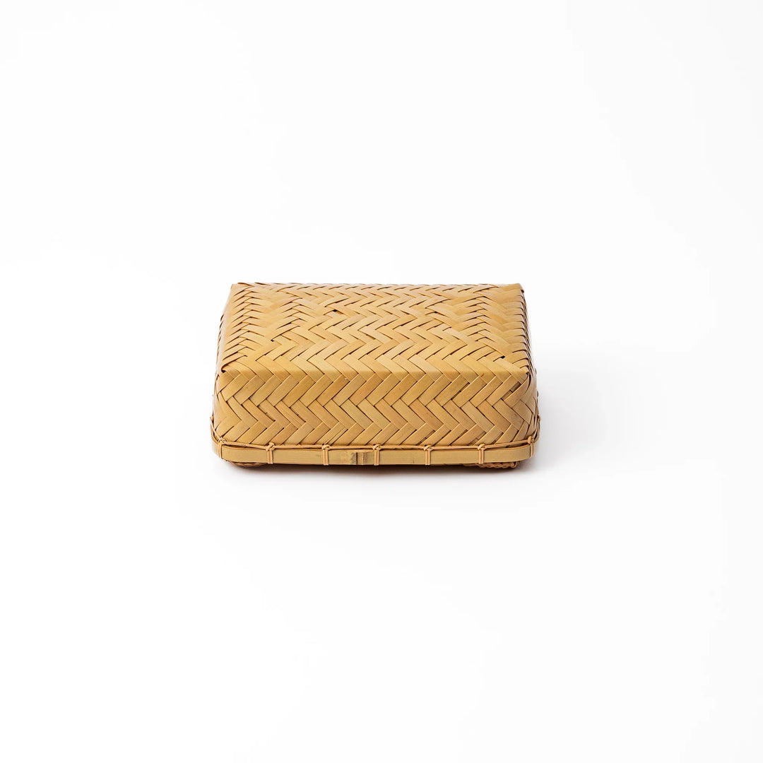 Traditional Japanese Ajiro weave bamboo bento box with a fitted lid showing intricate handcrafted diagonal patterns