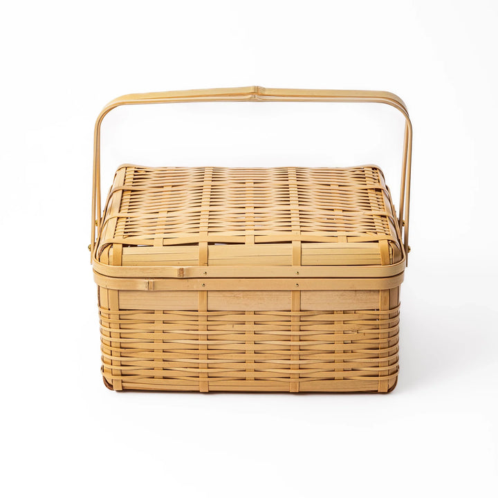 Large Japanese bamboo picnic basket with a sturdy arched handle and a fitted lid for outdoor dining and storage
