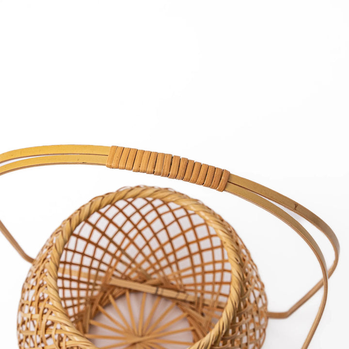 Handwoven Japanese bamboo Ikebana flower basket with a tall arched handle for traditional floral arrangements