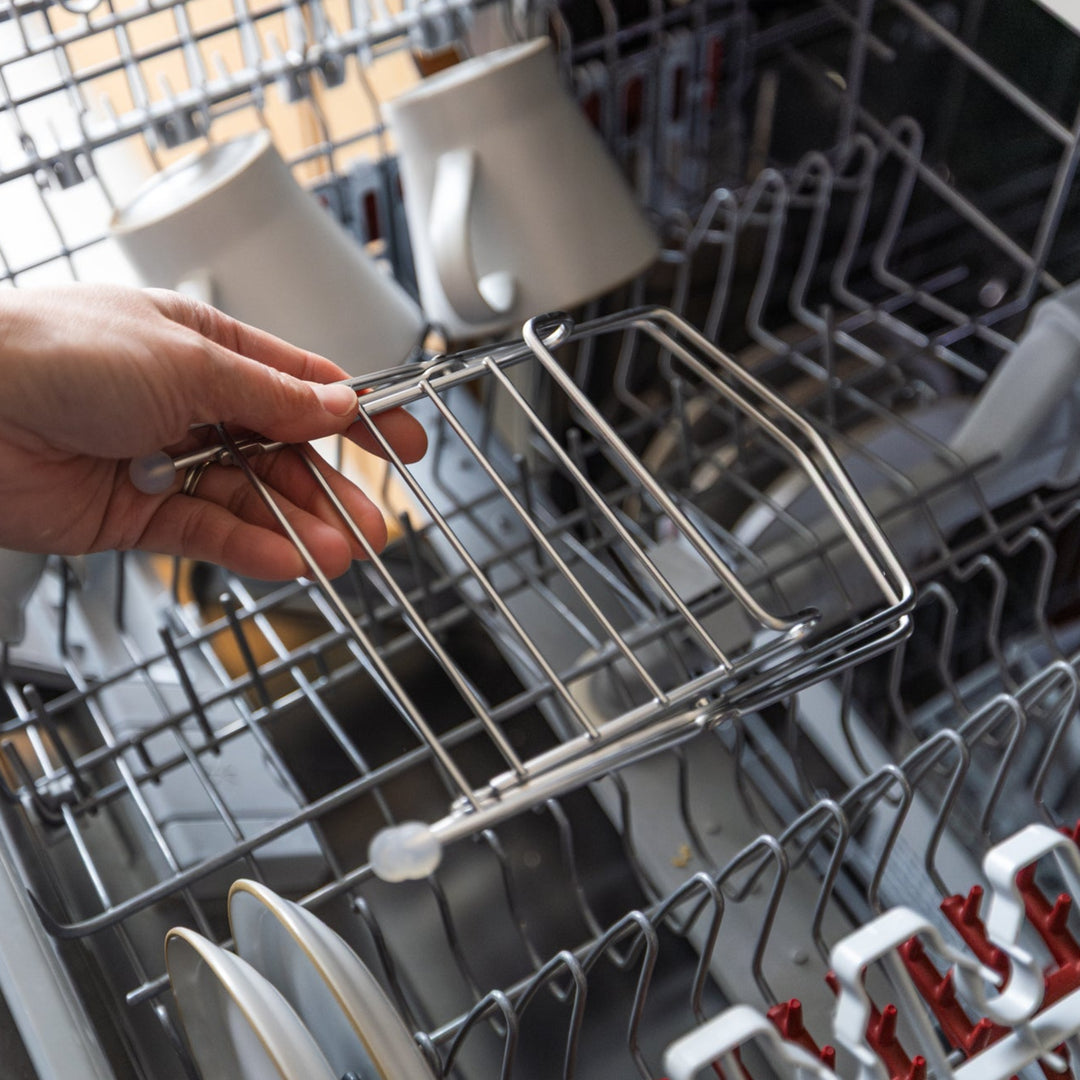 Nami loading dishwasher safe ecoframe stainless compost holder into automatic dish washing machine wire rack