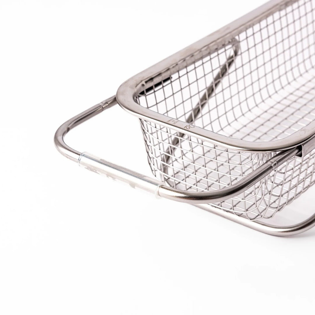Stainless steel rectangular strainer basket with handles for draining noodles or frying in Japanese cooking.