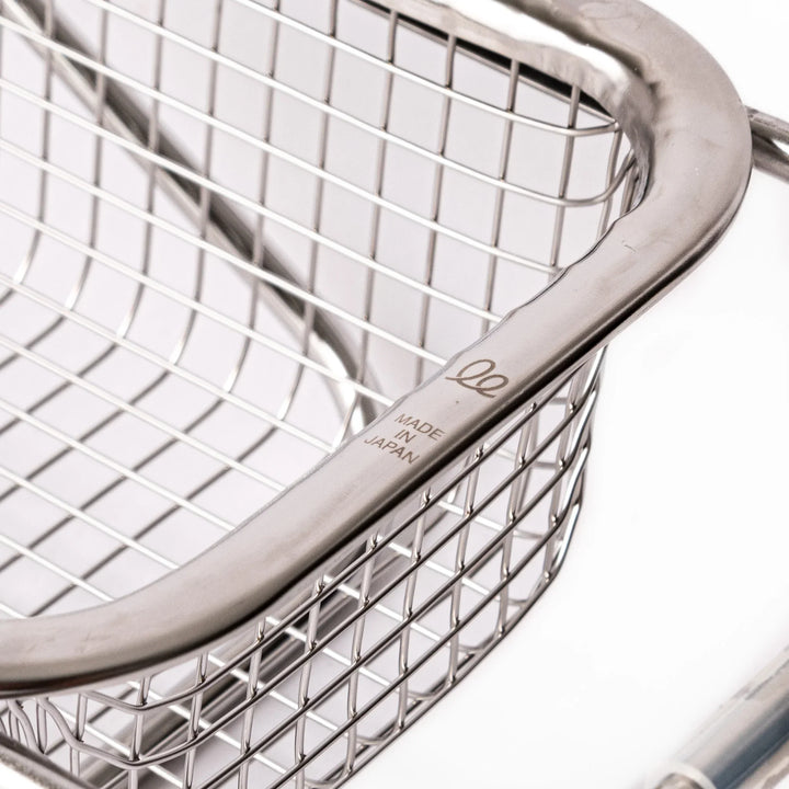 Stainless steel rectangular strainer basket with handles for draining noodles or frying in Japanese cooking.