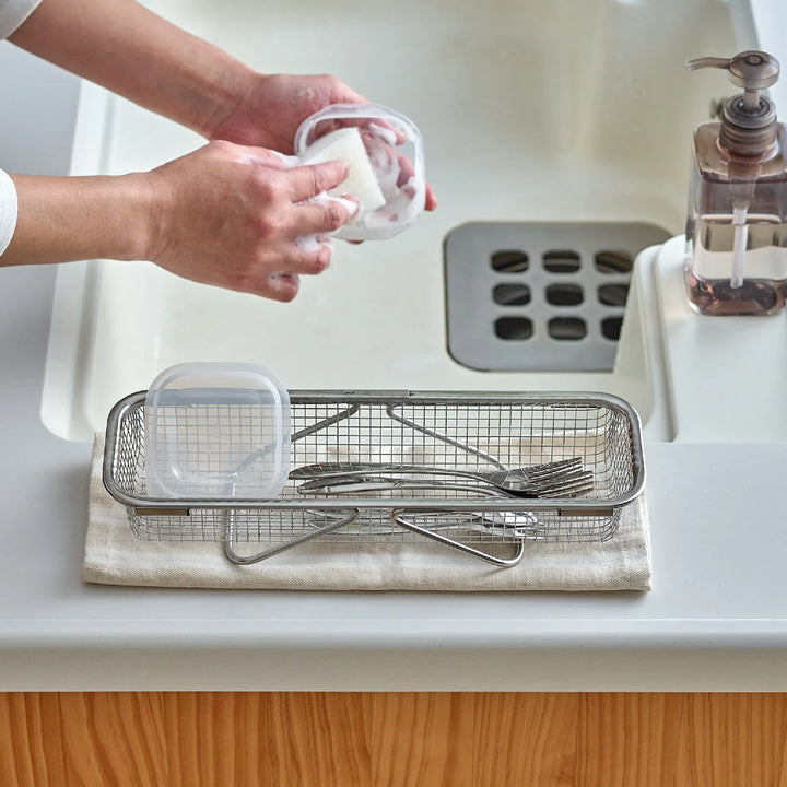 Stainless steel rectangular strainer basket with handles for draining noodles or frying in Japanese cooking.