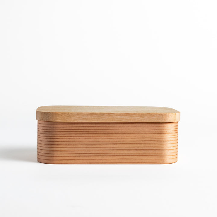 Artisan Cedar Bento Box with lid on, showcasing the natural cedar wood grain and rounded edges for a minimalist and elegant look.