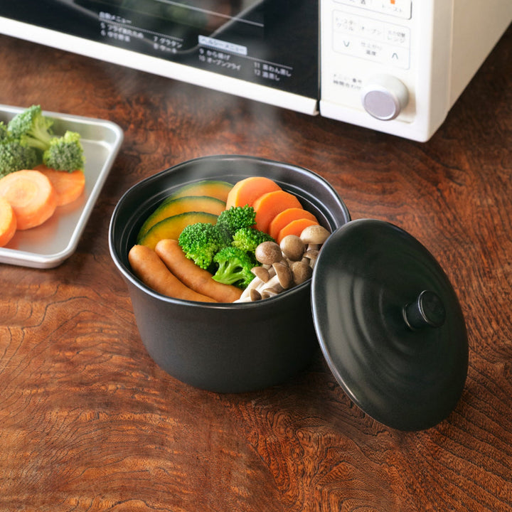 Black Ceramic Floral Ridge Rice Storage Bowl with lid, microwave-safe for steaming vegetables and cooking healthy Japanese meals.