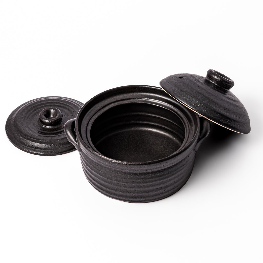 Black clay donabe with induction-compatible design, featuring double lid and side handles, ideal for cooking 2 cups of rice.