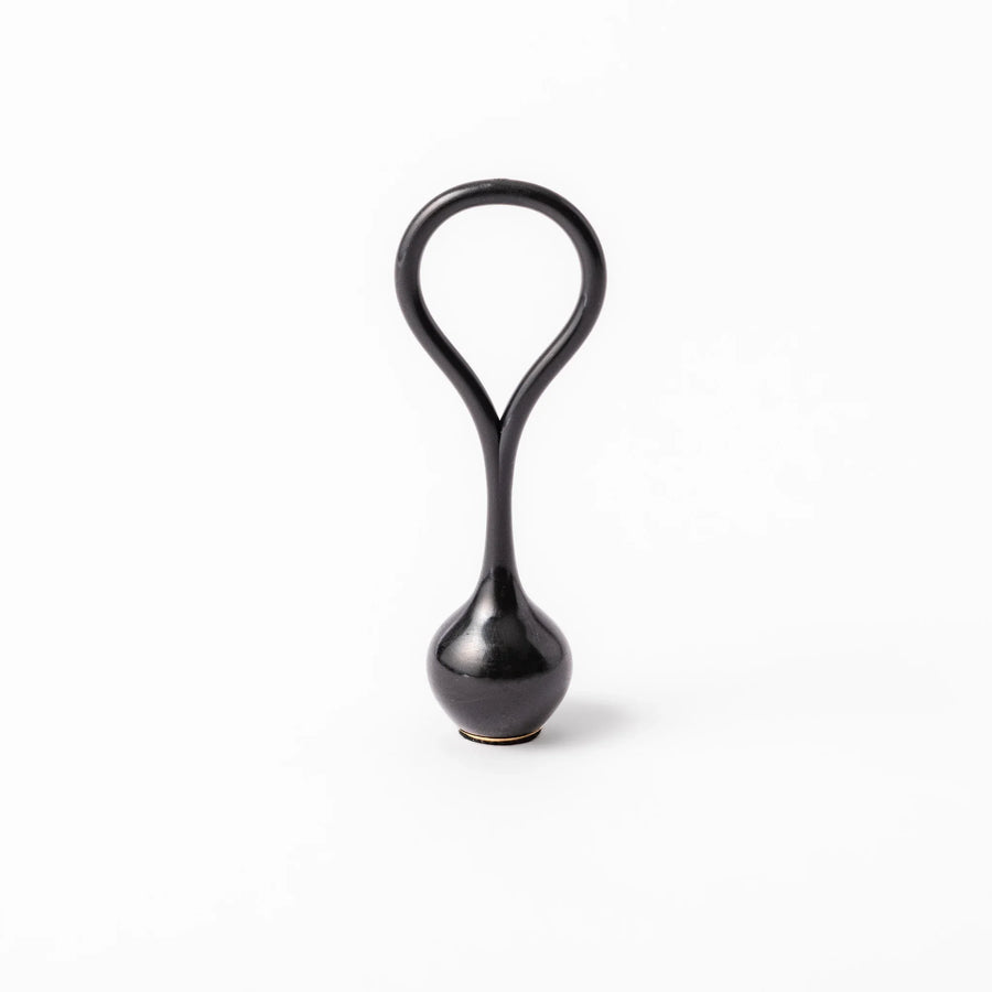 Black meditation bowl striker with looped handle and felt tip for gentle resonant sounds in prayer rituals.