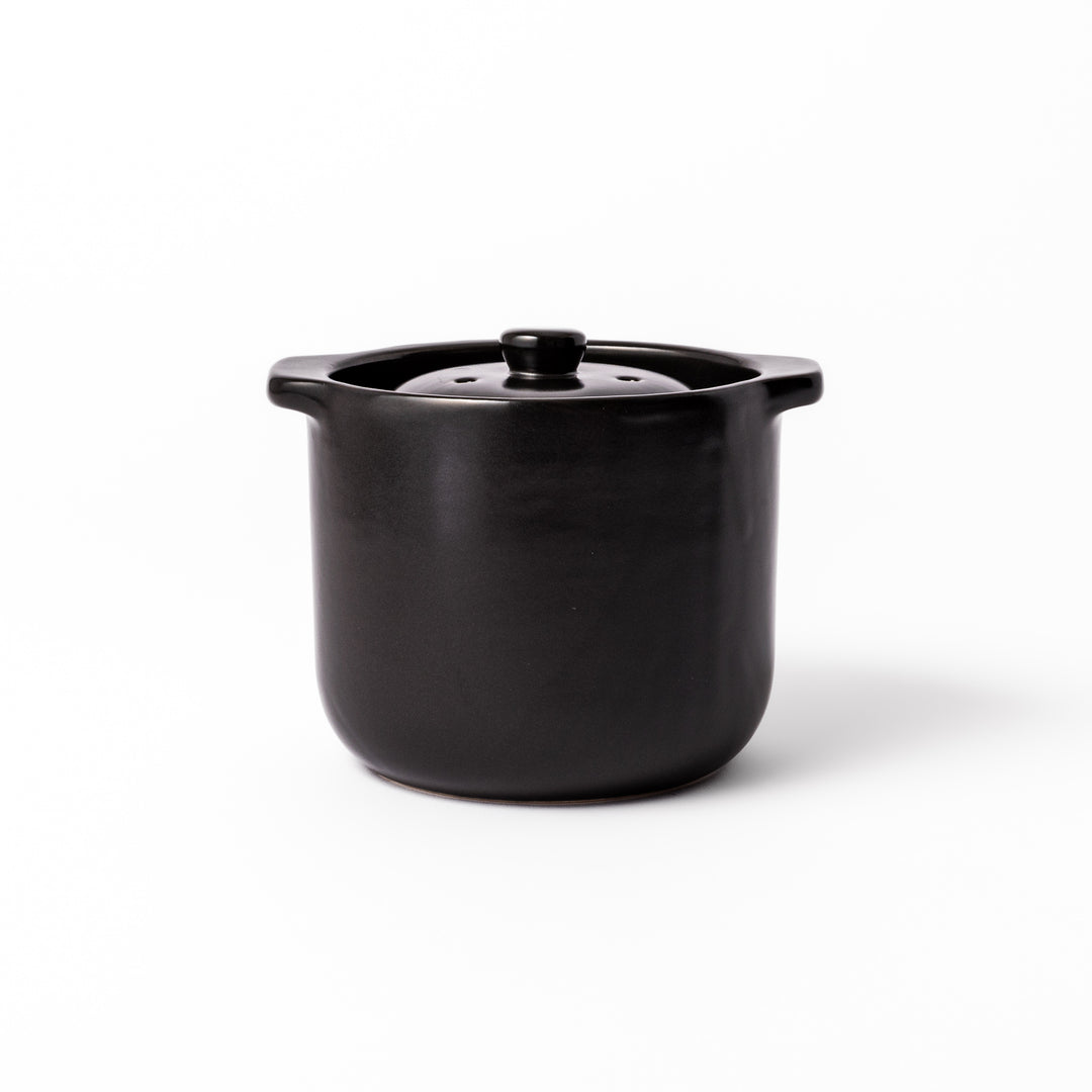 Black ceramic microwave rice cooker with double lid and side handles, designed for convenient cooking and serving at the table.