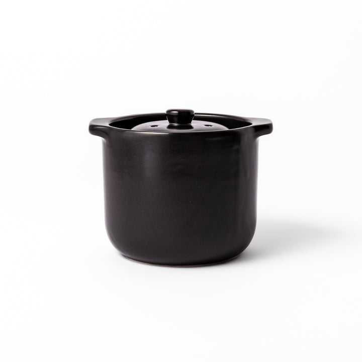 Black ceramic microwave rice cooker with double lid and side handles, designed for convenient cooking and serving at the table.