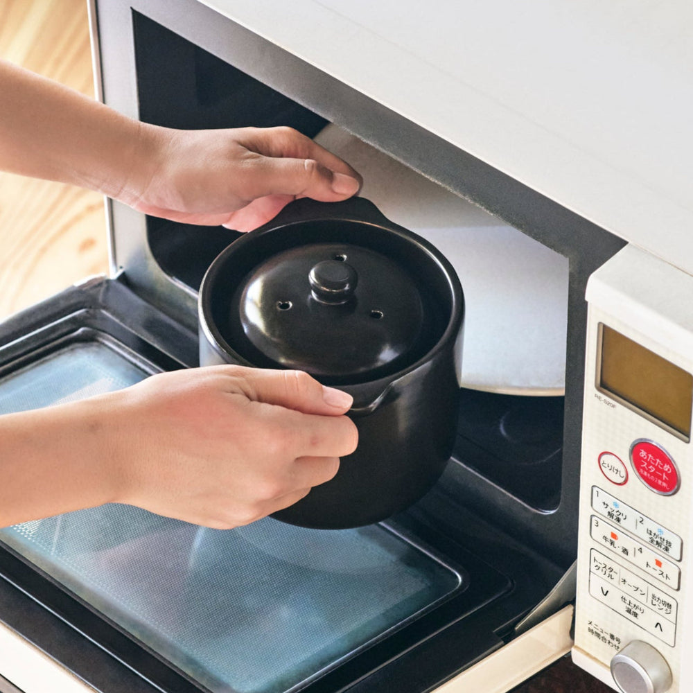 Black Microwave Rice Cooker with Double Lid, designed for quick cooking and steaming fluffy rice with authentic Japanese style.