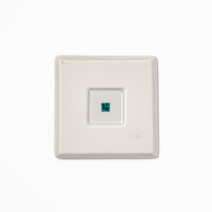 Square Japanese ceramic coaster with vivid red base featuring peony, chrysanthemum, and floral motifs in multicolor design.