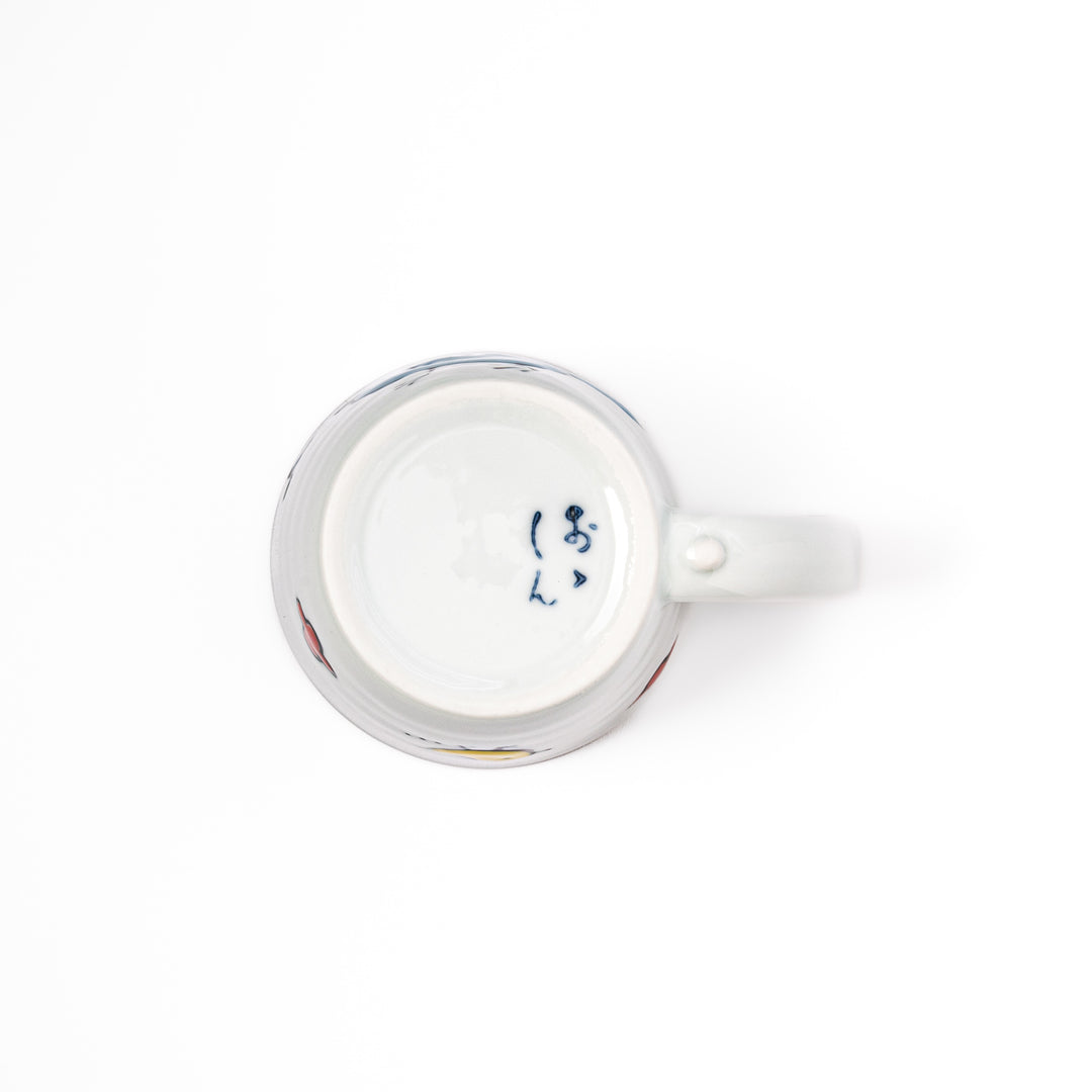 Japanese children’s mug featuring a hand-painted blue bird and musical note design on white porcelain, crafted for little hands to enjoy warm drinks with joy.