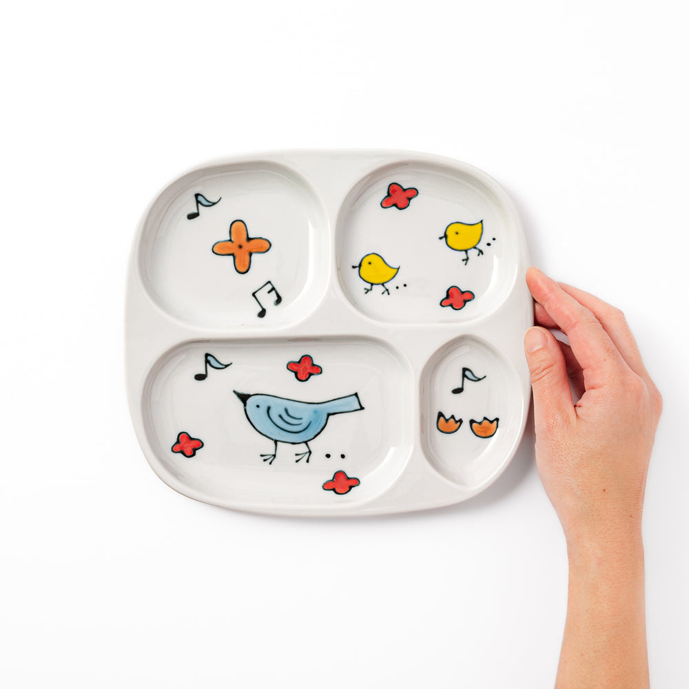 Japanese children’s divided plate decorated with colorful blue and yellow birds, flowers, and musical notes, designed for fun and easy mealtime organization.