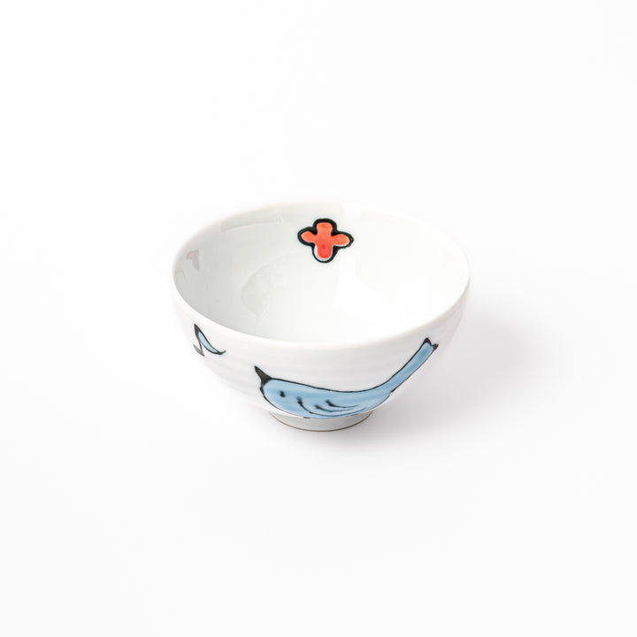 Japanese children’s rice bowl featuring a hand-painted blue bird and musical note motif on white porcelain, designed to bring a cheerful touch to everyday meals.
