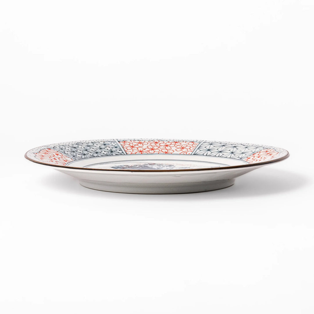 Japanese porcelain dinner plate featuring Hokusai Great Wave design with red and blue geometric border patterns.