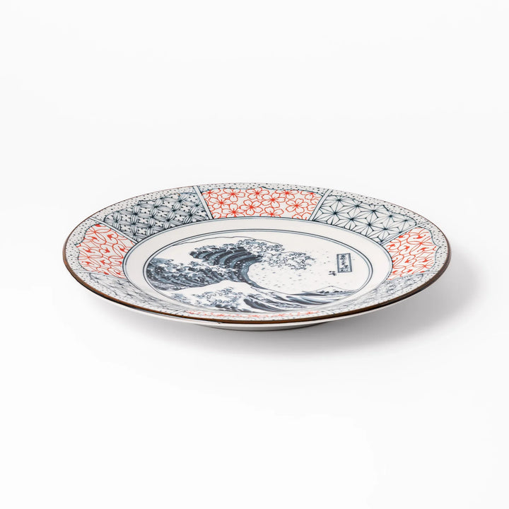 Japanese porcelain dinner plate featuring Hokusai Great Wave design with red and blue geometric border patterns.