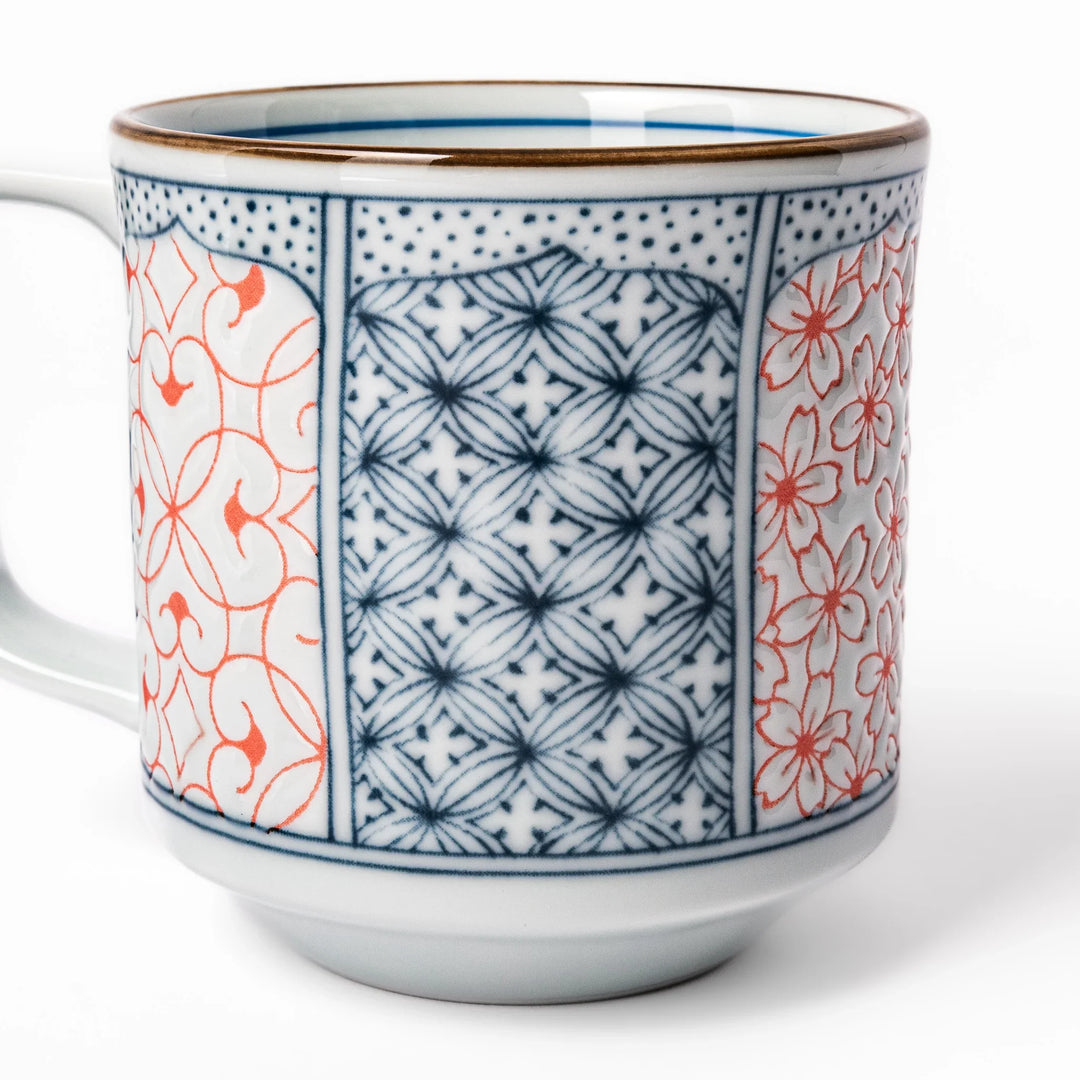 Japanese porcelain mug featuring Hokusai Great Wave and red-blue geometric patterns, crafted with elegant traditional design.