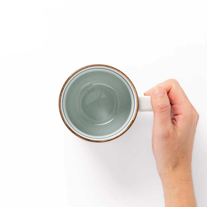 Japanese porcelain mug featuring Hokusai Great Wave and red-blue geometric patterns, crafted with elegant traditional design.