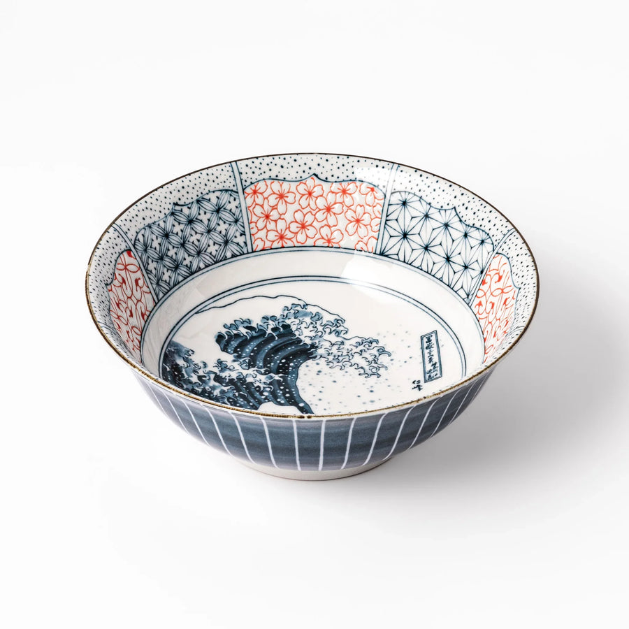 Japanese porcelain ramen bowl featuring Hokusai Great Wave design with red and blue geometric patterns in traditional style.