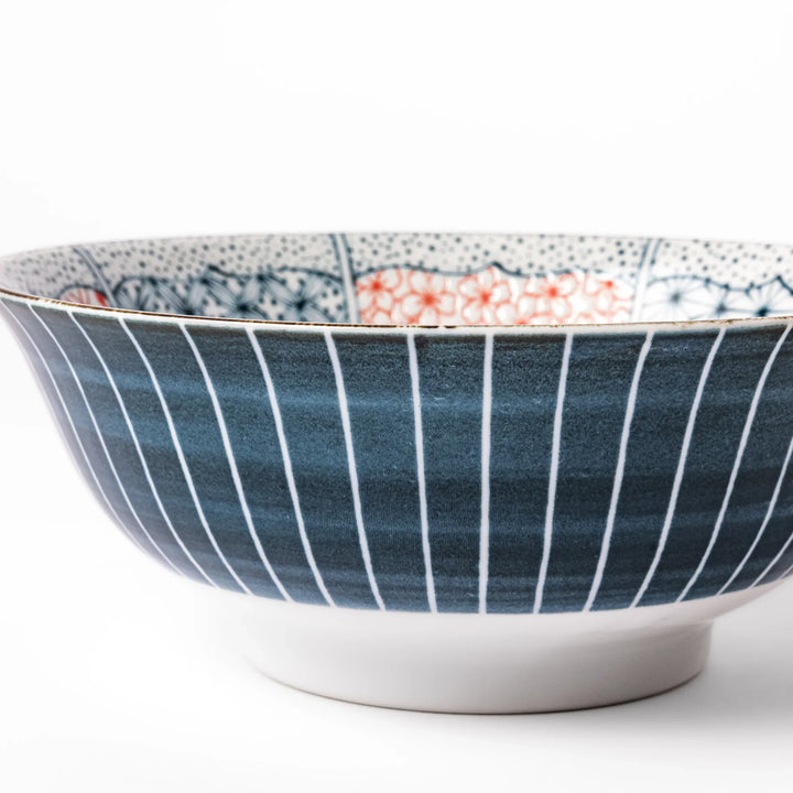Japanese porcelain ramen bowl featuring Hokusai Great Wave design with red and blue geometric patterns in traditional style.