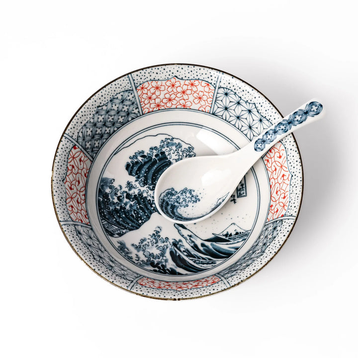 Japanese porcelain ramen bowl and spoon featuring Hokusai Great Wave design with red and blue geometric border patterns.