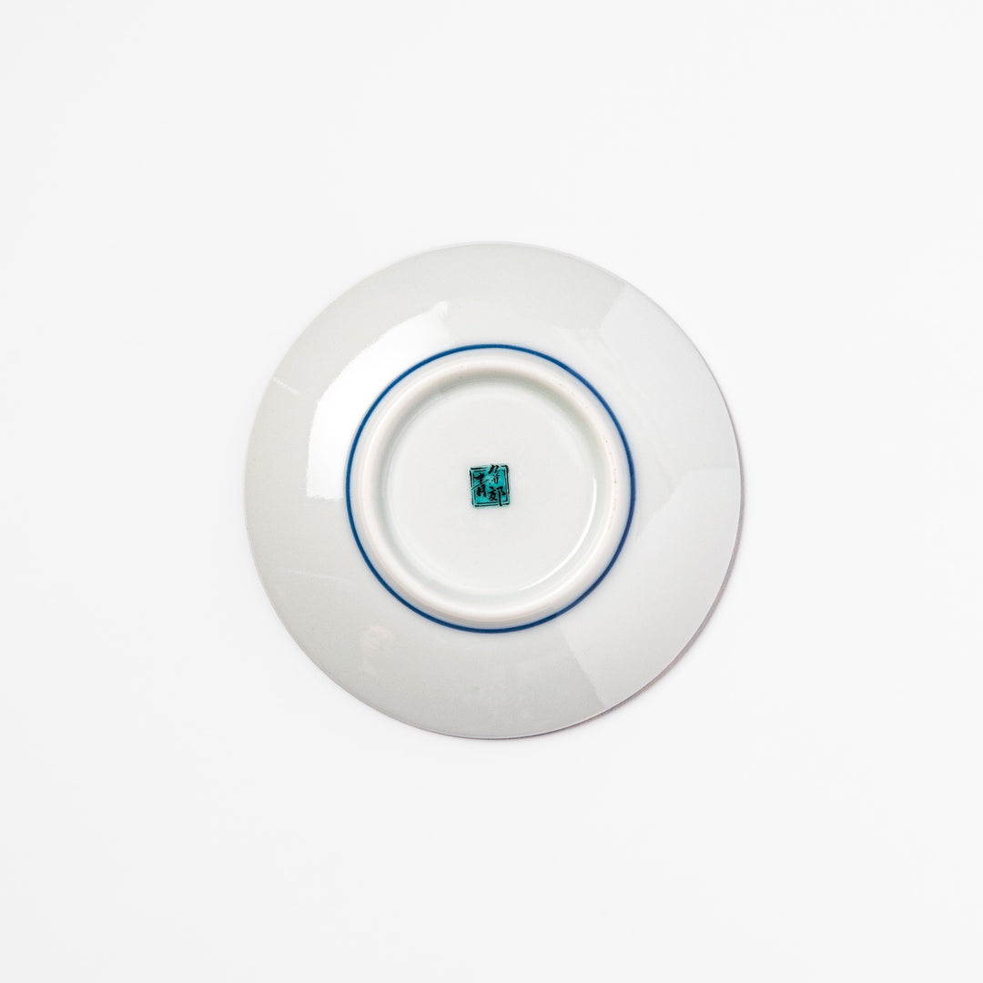 Blue Japanese ceramic sauce dish adorned with white sakura blossom and petals, ideal for traditional dining and serving soy sauce or condiments.