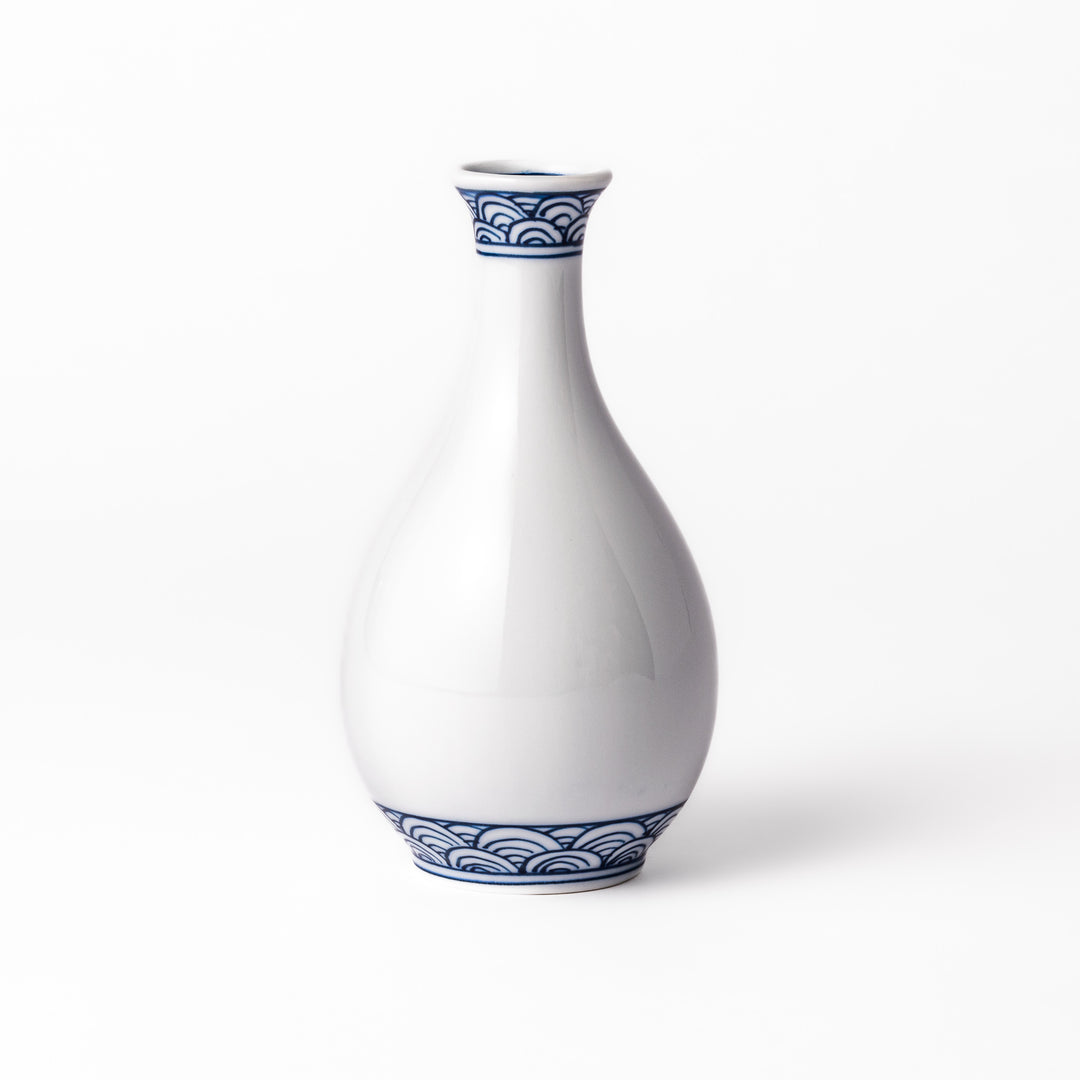 Porcelain sake flask with a smooth white body accented by traditional blue seigaiha wave patterns around the neck and base.