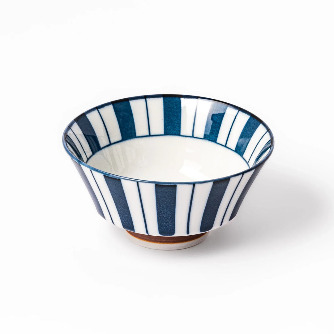 Japanese porcelain rice bowl with bold indigo and white stripe pattern and terracotta base, crafted in modern traditional style.