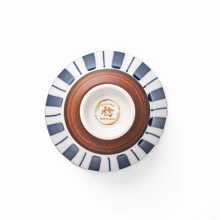 Japanese porcelain rice bowl with bold indigo and white stripe pattern and terracotta base, crafted in modern traditional style.