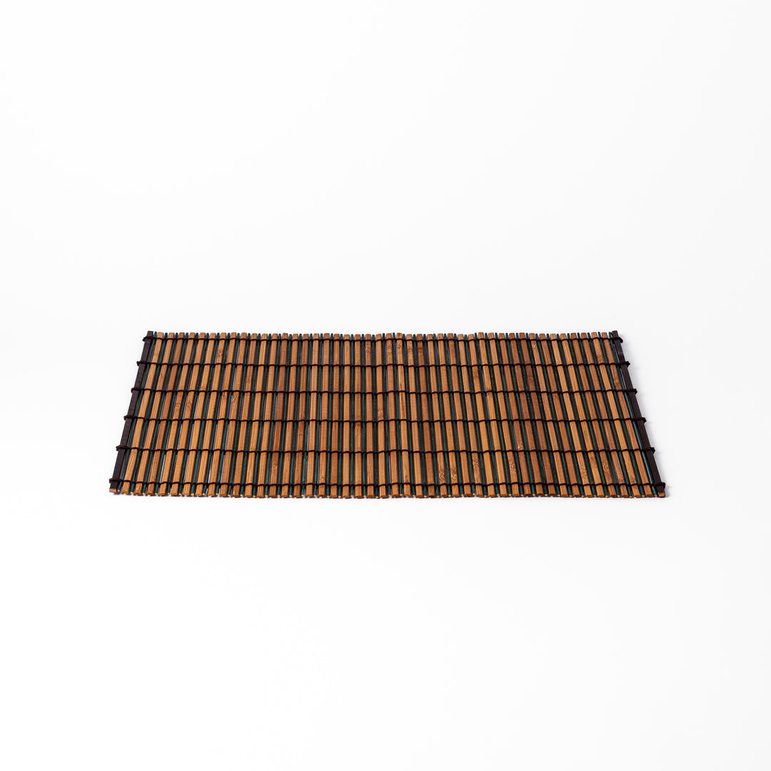Brown bamboo table mat featuring alternating dark and natural slats bound with black cord, perfect for warm, earthy Japanese-inspired table settings.