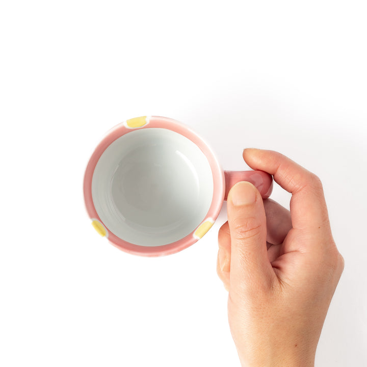 Adorable pink kids' mug featuring a cute bunny design and yellow accents, perfect for young children and adding a fun touch to mealtime.