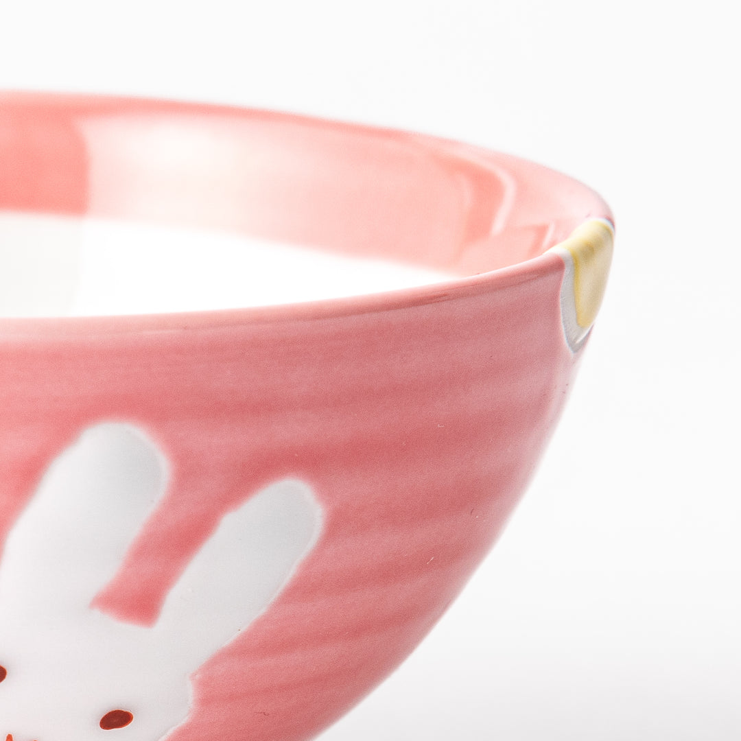 Charming pink kids' rice bowl featuring a cute bunny illustration and yellow accents, perfect for adding a playful touch to mealtime.
