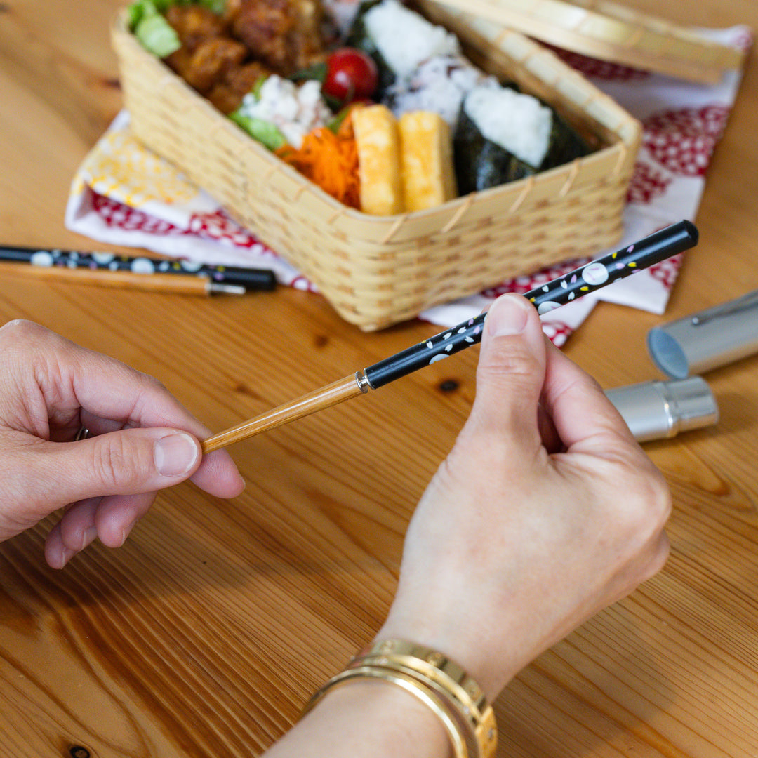 Nami from Just One Cookbook assembling bunny portable Japanese travel chopsticks with a screw on black rabbit print handle