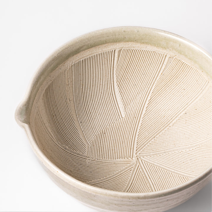 Celadon green Japanese suribachi mortar with finely grooved interior and pouring spout, perfect for grinding sesame seeds and preparing traditional sauces.