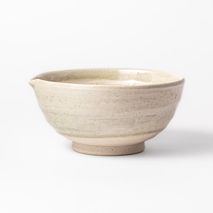 Celadon green Japanese suribachi mortar with finely grooved interior and pouring spout, perfect for grinding sesame seeds and preparing traditional sauces.