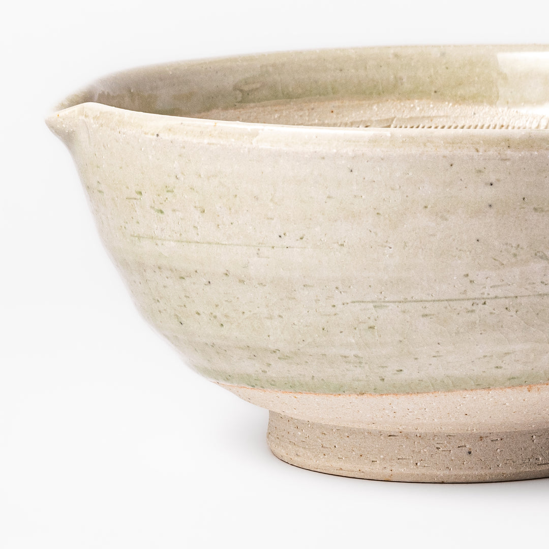 Celadon green Japanese suribachi mortar with finely grooved interior and pouring spout, perfect for grinding sesame seeds and preparing traditional sauces.