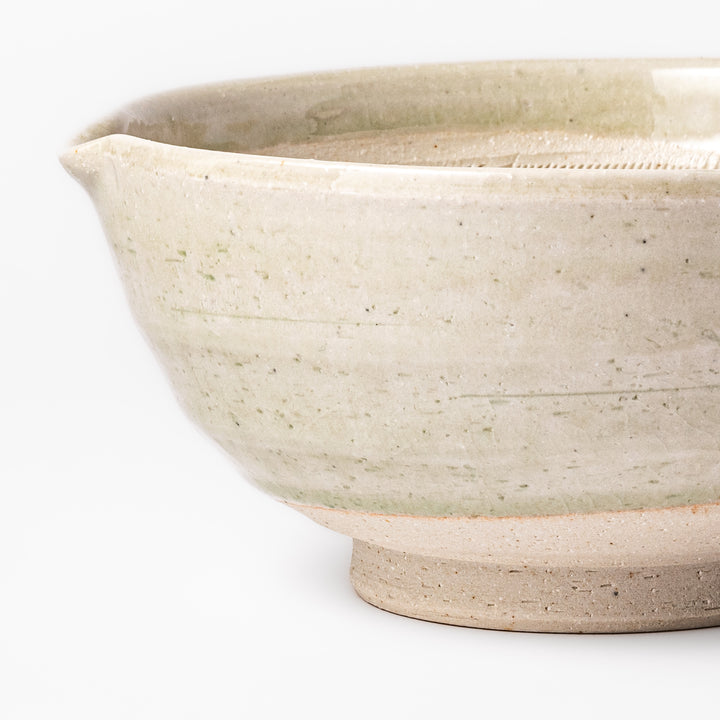 Celadon green Japanese suribachi mortar with finely grooved interior and pouring spout, perfect for grinding sesame seeds and preparing traditional sauces.