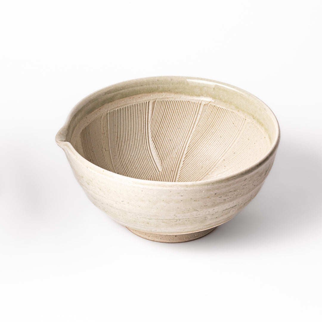 Celadon green Japanese suribachi mortar with finely grooved interior and pouring spout, perfect for grinding sesame seeds and preparing traditional sauces.