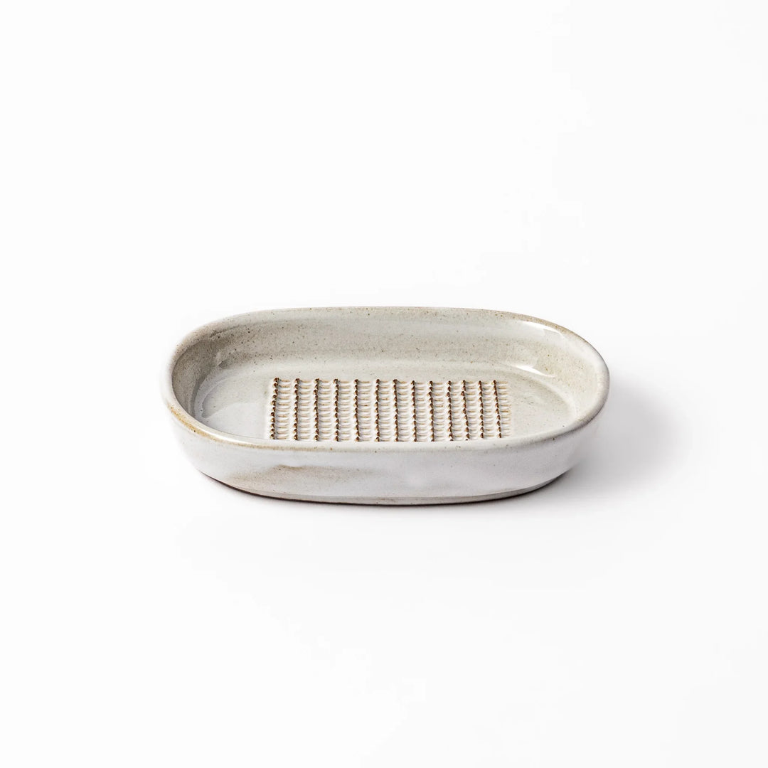 White ceramic ginger grater dish with a natural glaze and raised teeth, ideal for finely grating ginger, garlic, or wasabi with minimal effort.