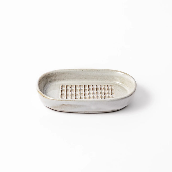 White ceramic ginger grater dish with a natural glaze and raised teeth, ideal for finely grating ginger, garlic, or wasabi with minimal effort.