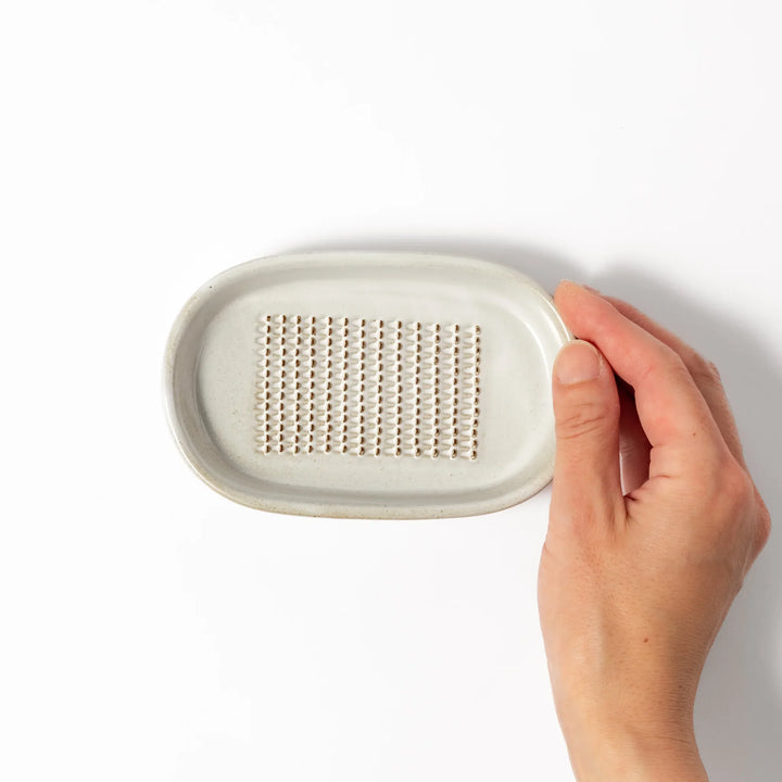 White ceramic ginger grater dish with a natural glaze and raised teeth, ideal for finely grating ginger, garlic, or wasabi with minimal effort.