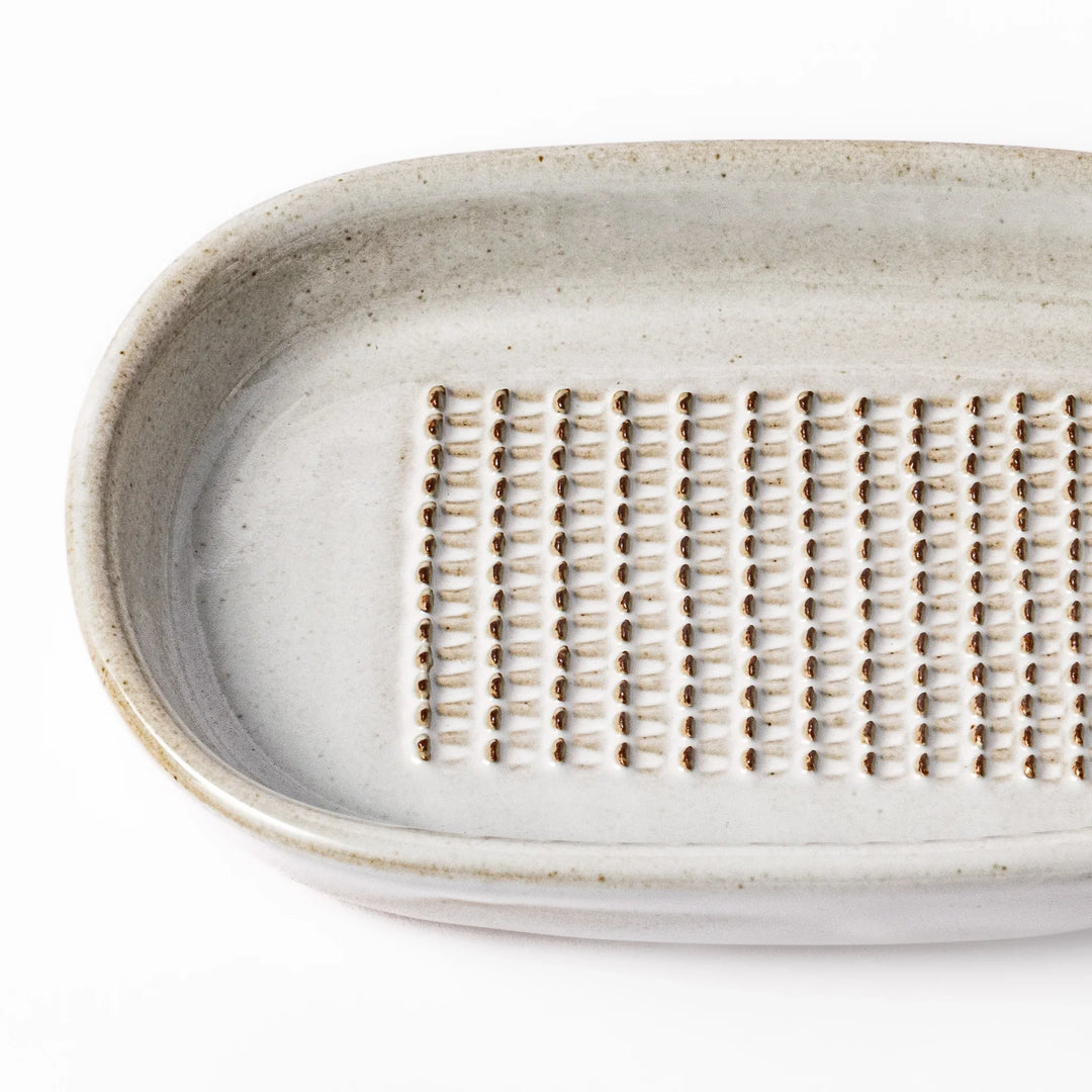 White ceramic ginger grater dish with a natural glaze and raised teeth, ideal for finely grating ginger, garlic, or wasabi with minimal effort.