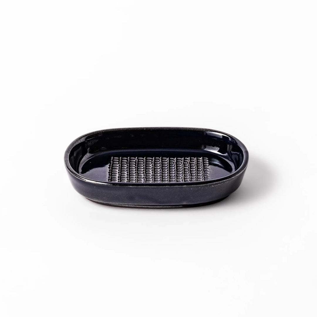 Deep blue ceramic ginger grater dish with raised teeth and a shallow base, designed for efficiently grating ginger, garlic, or daikon.