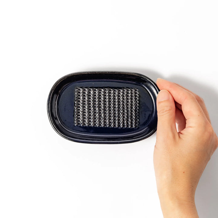 Deep blue ceramic ginger grater dish with raised teeth and a shallow base, designed for efficiently grating ginger, garlic, or daikon.